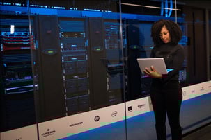 A woman standing next to a data center